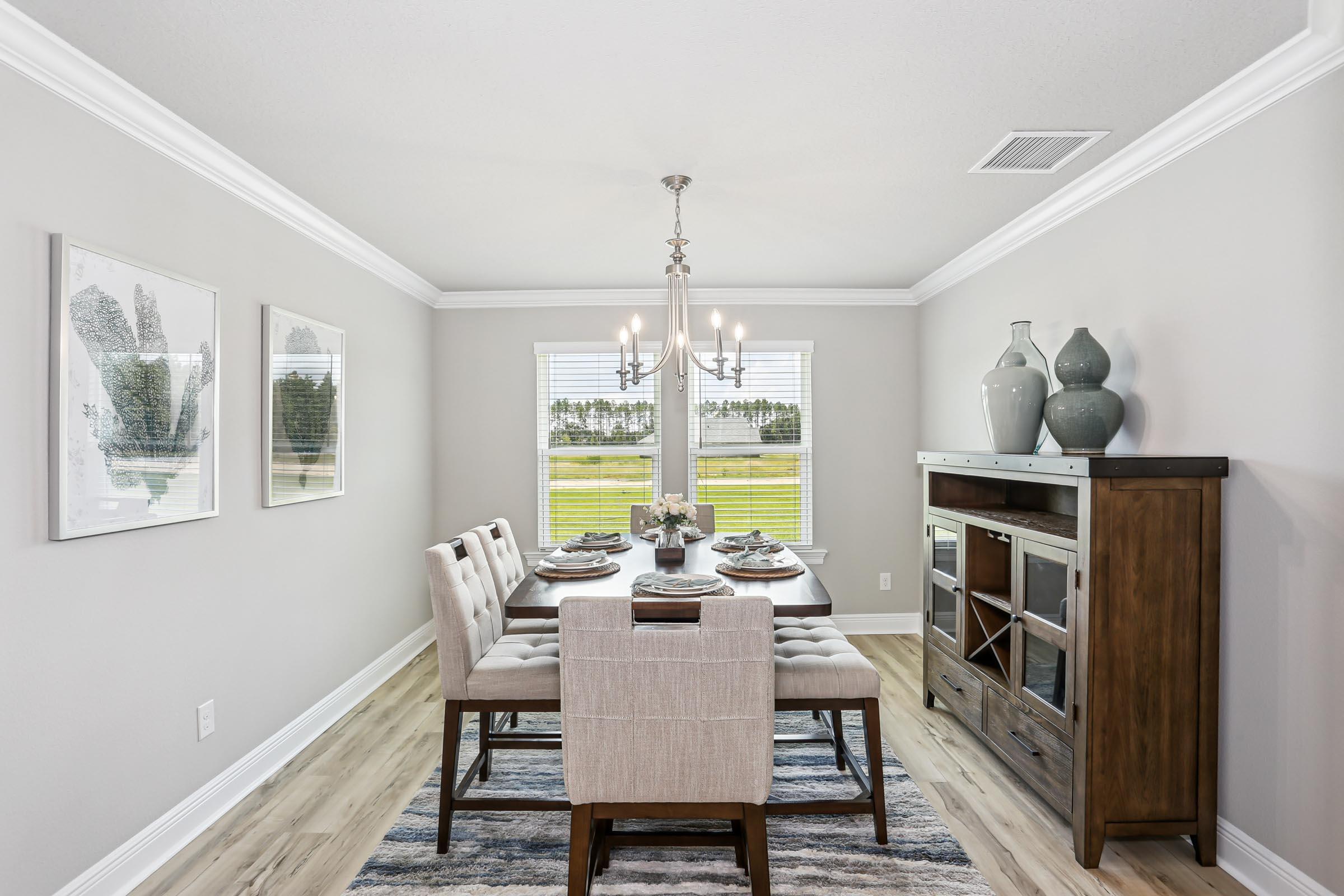 4863 Horace Lunsford Road Milton, FL 32570 - Photo 14 of 36 a view of a dining room with furniture a chandelier and wooden floor