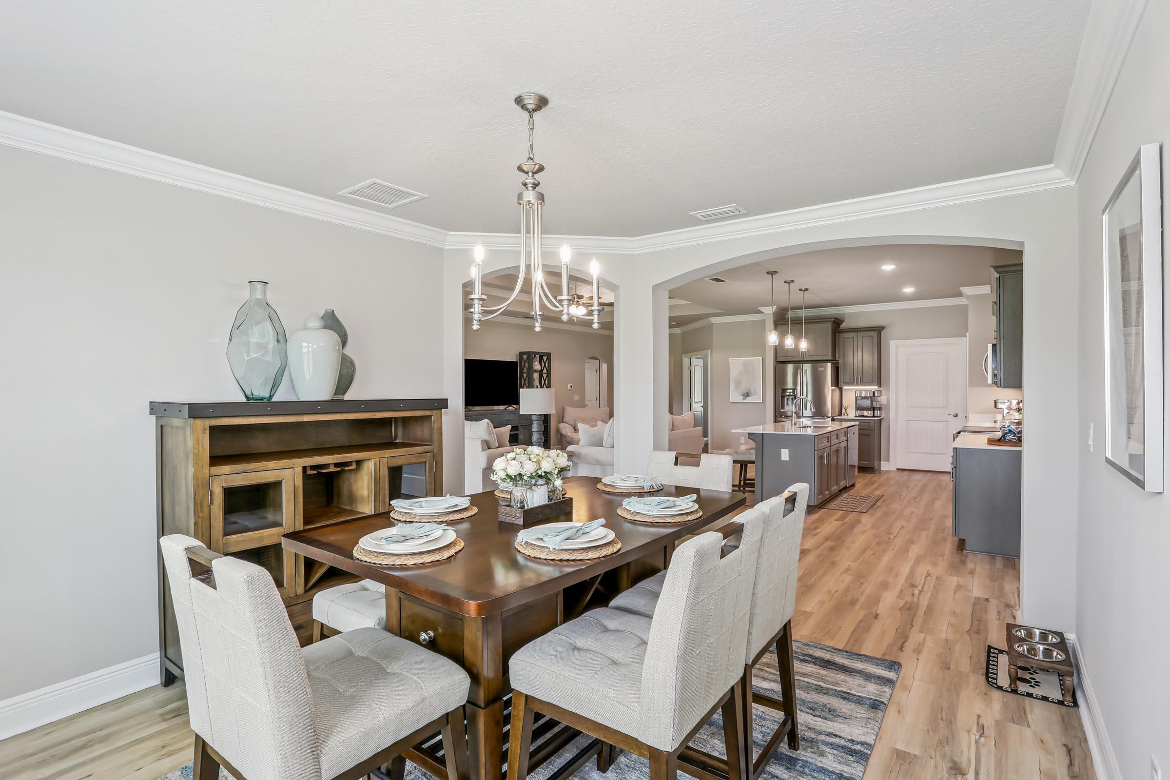 4863 Horace Lunsford Road Milton, FL 32570 - Photo 15 of 36 a view of a dining room with furniture wooden floor and a chandelier