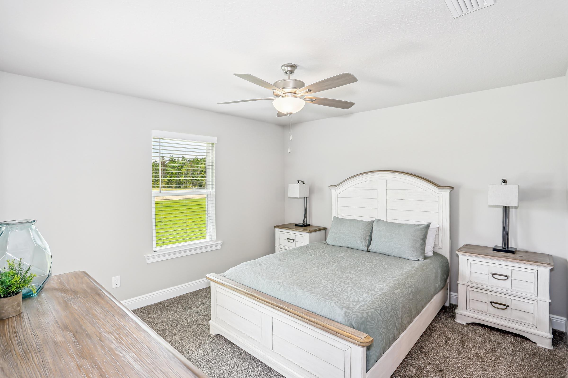 4863 Horace Lunsford Road Milton, FL 32570 - Photo 23 of 36 a bedroom with a bed and a chandelier
