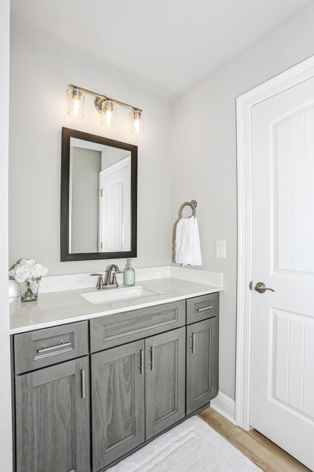 4863 Horace Lunsford Road Milton, FL 32570 - Photo 26 of 36 a en suite bathroom with a double vanity sink and a mirror