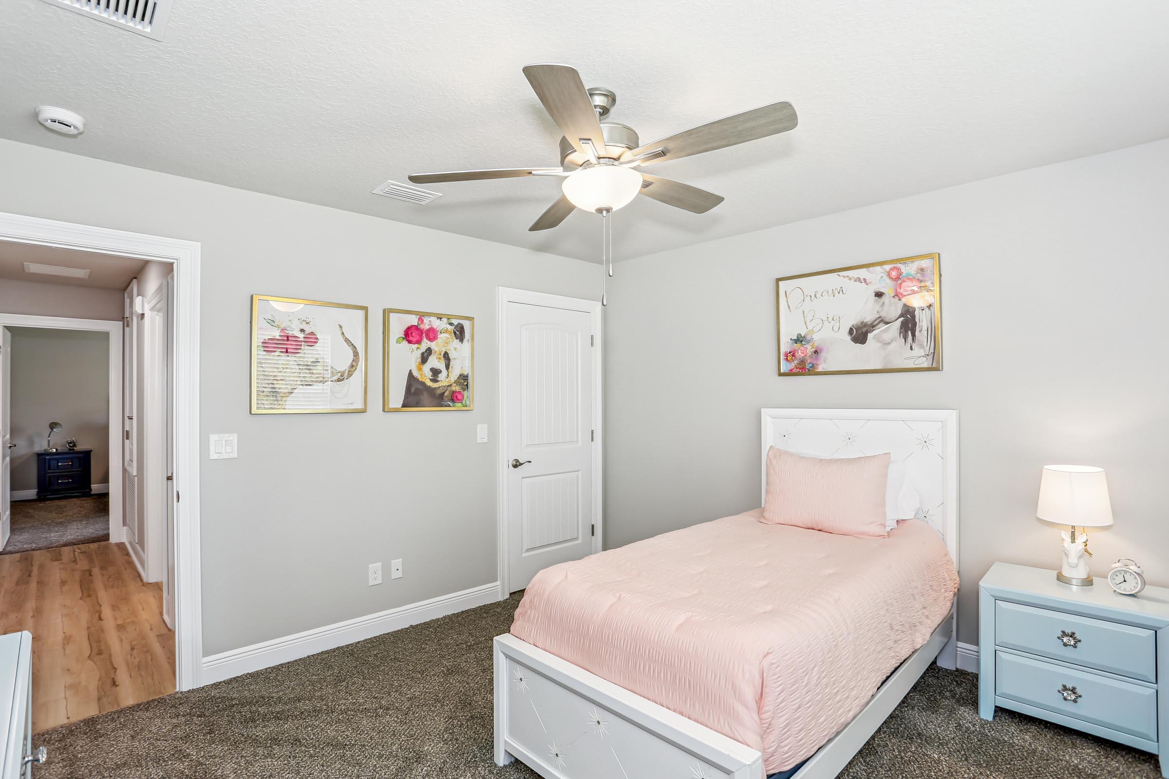 4863 Horace Lunsford Road Milton, FL 32570 - Photo 30 of 36 a bedroom with a bed and a chandelier