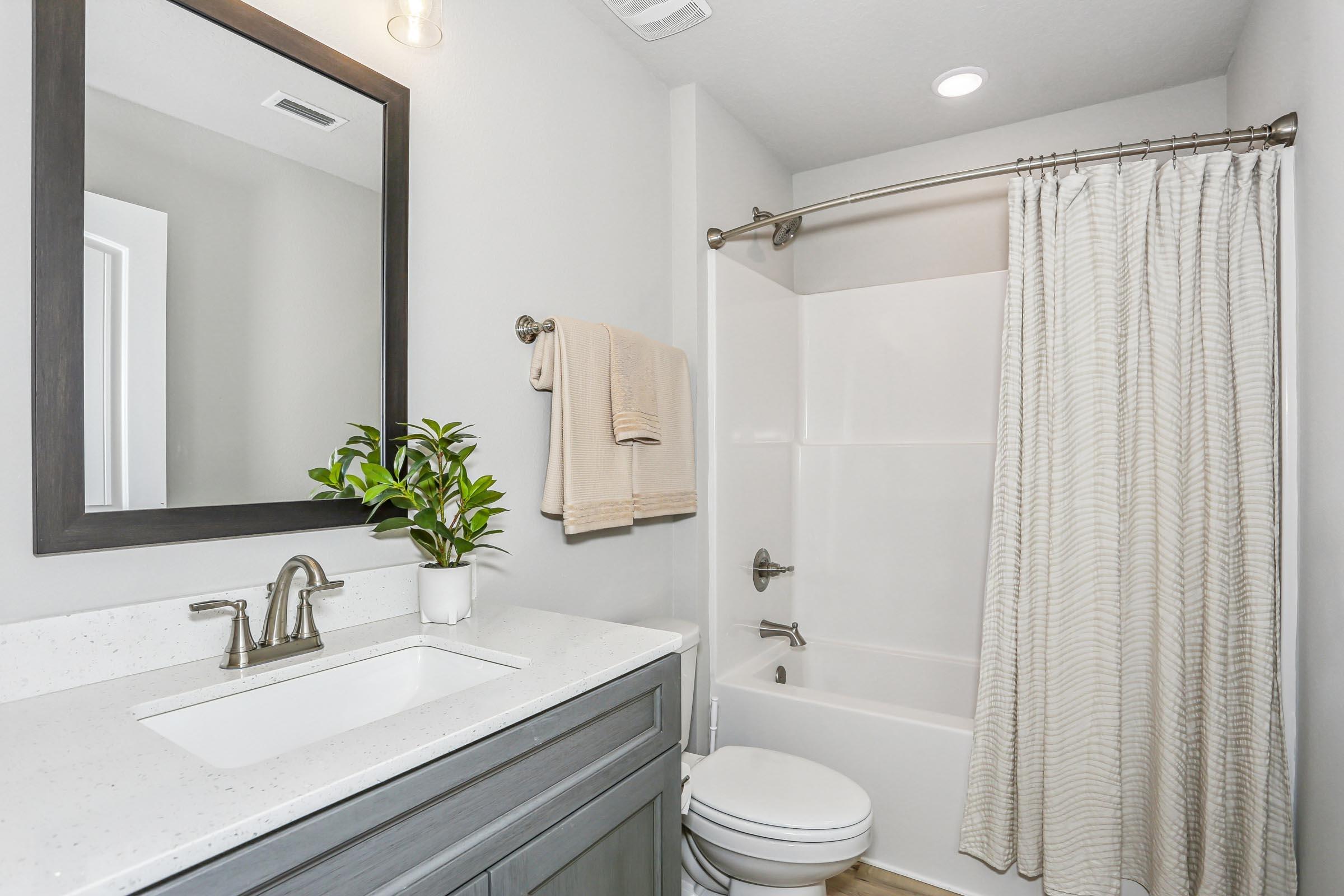 4863 Horace Lunsford Road Milton, FL 32570 - Photo 31 of 36 a bathroom with a sink a toilet a tub and shower