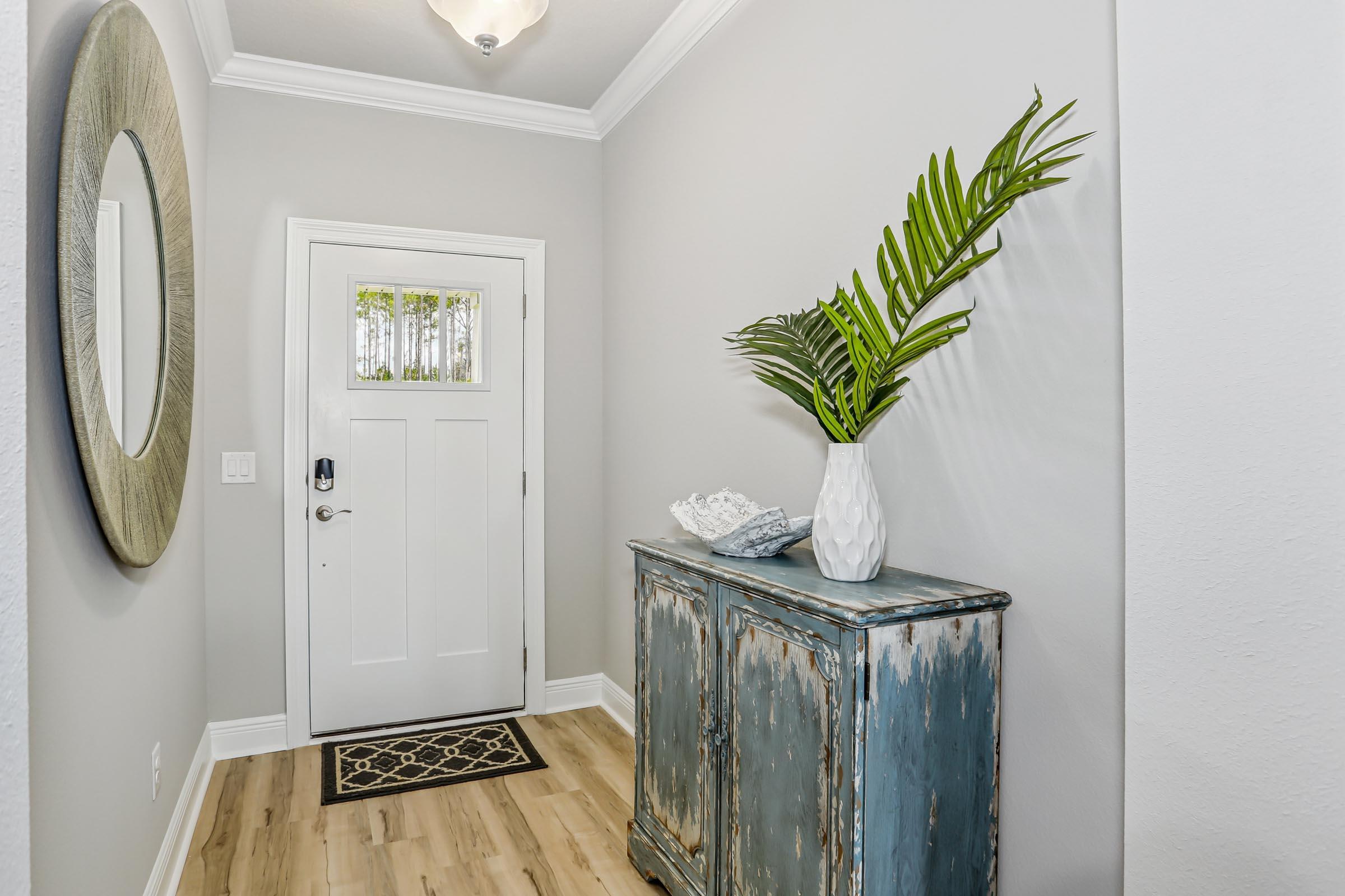 4863 Horace Lunsford Road Milton, FL 32570 - Photo 6 of 36 a view of a hallway with wooden floor and a potted plant