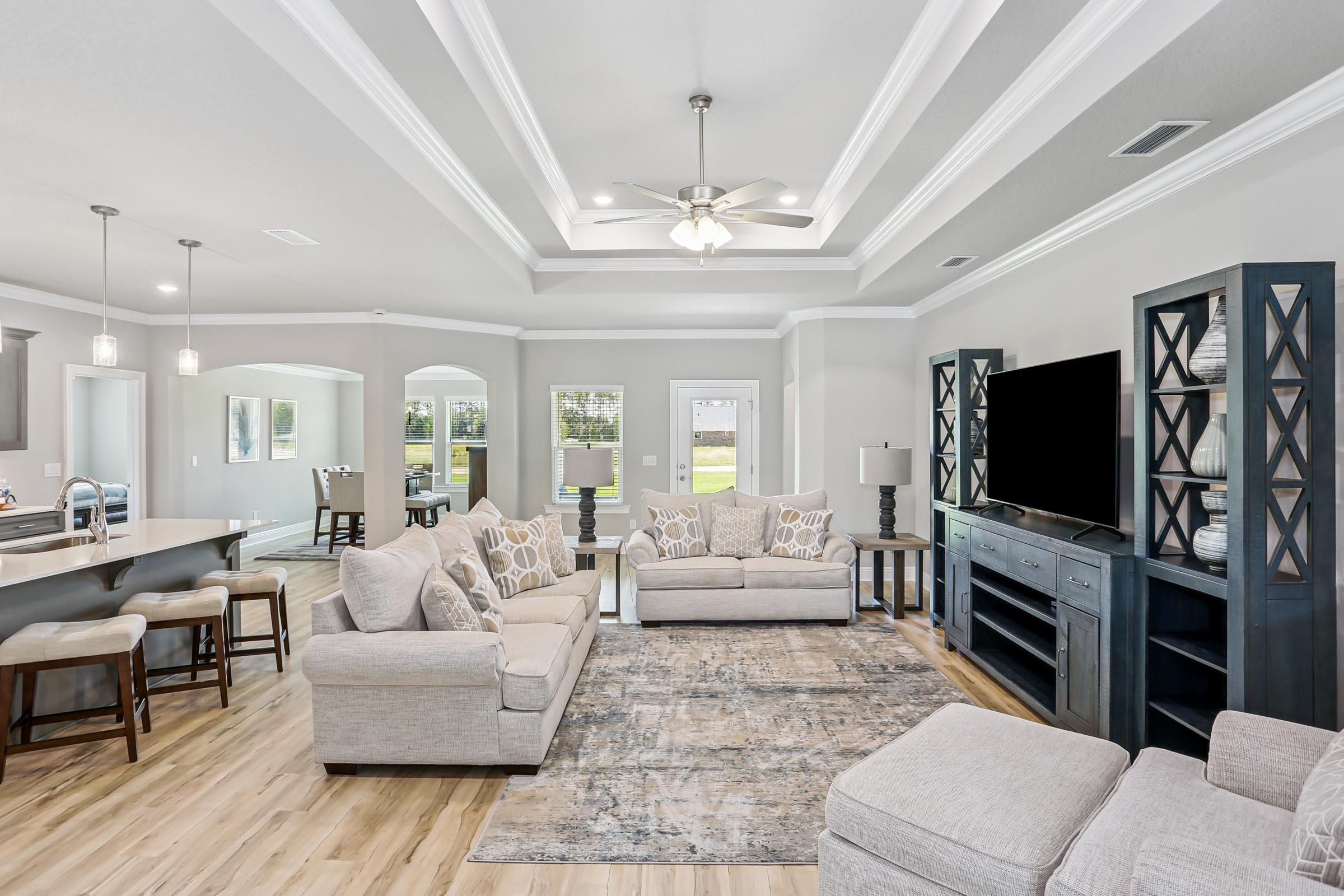 4863 Horace Lunsford Road Milton, FL 32570 - Photo 7 of 36 a living room with furniture a chandelier and a flat screen tv