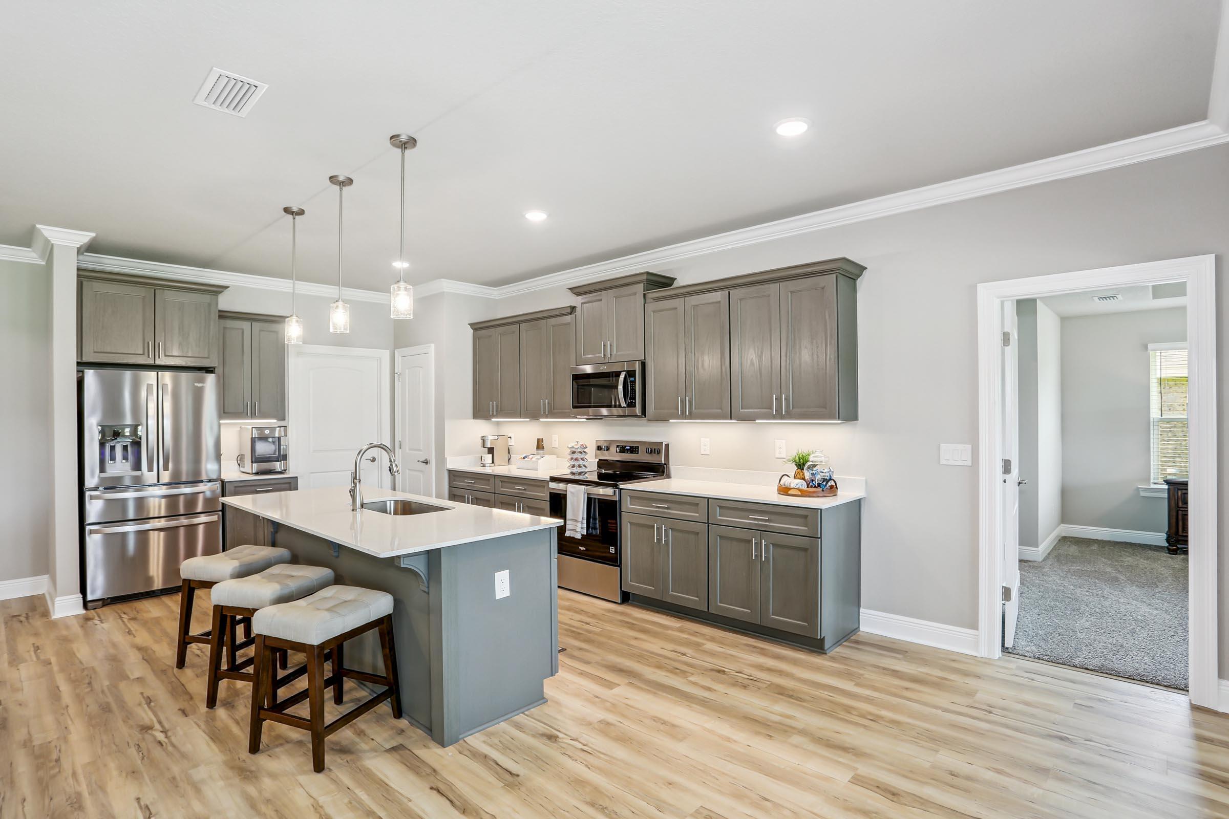 4863 Horace Lunsford Road Milton, FL 32570 - Photo 10 of 36 a kitchen with stainless steel appliances kitchen island granite countertop a stove refrigerator and cabinets