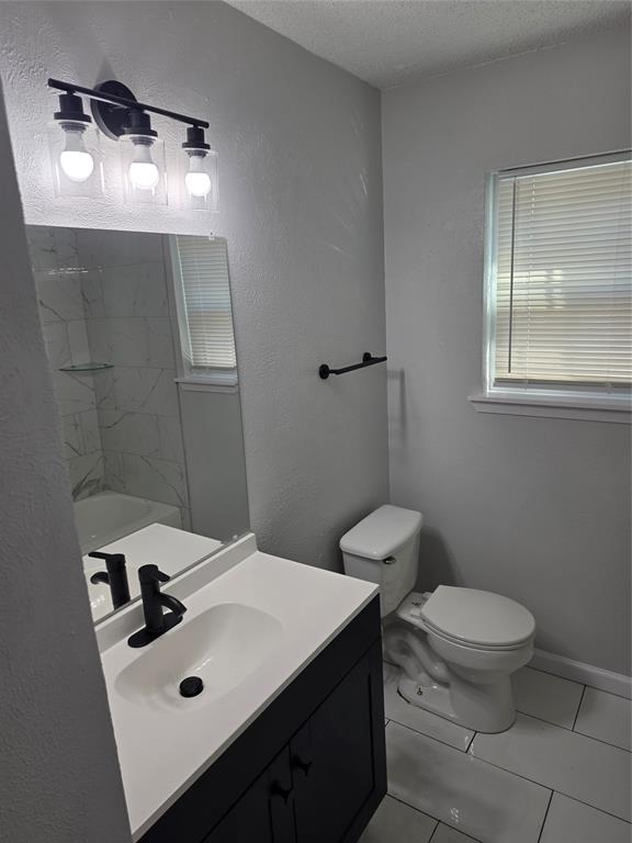 3005 Farrell Lane Fort Worth, TX 76119 - Photo 11 of 16 a bathroom with a sink a toilet and mirror