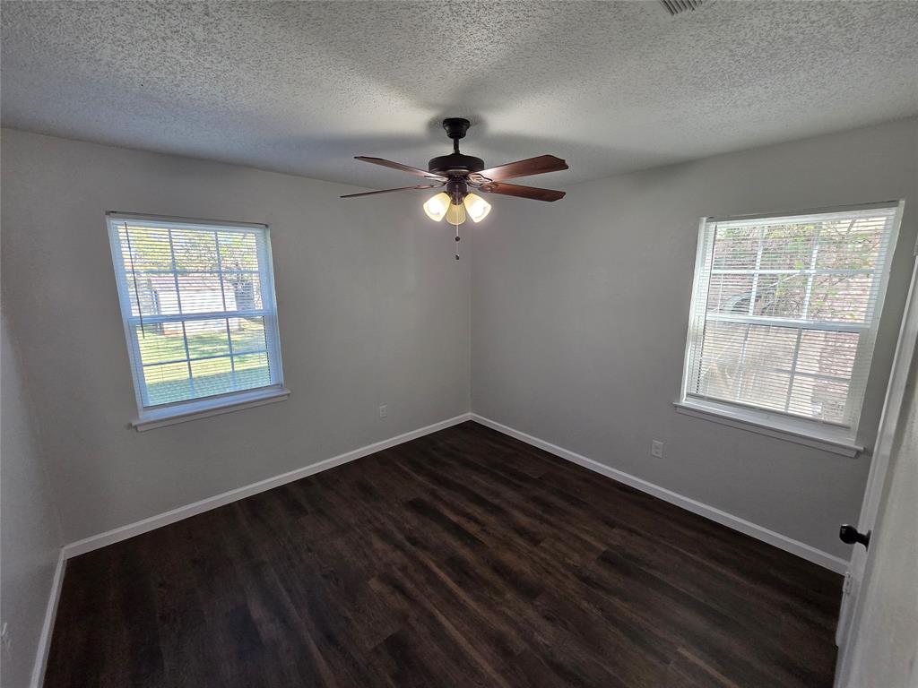 3005 Farrell Lane Fort Worth, TX 76119 - Photo 13 of 16 an empty room with a window and a ceiling fan