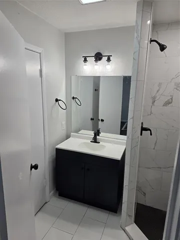 a bathroom with a sink vanity and mirror