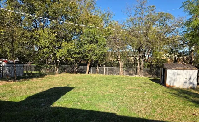 a view of yard with swimming pool and seating area