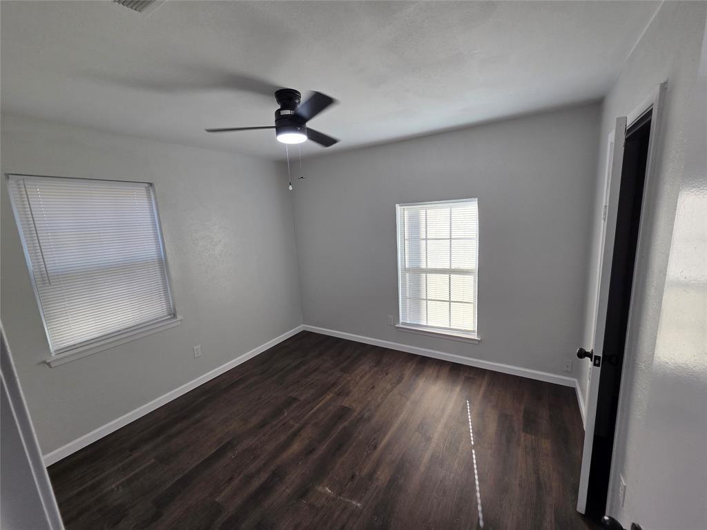 3005 Farrell Lane Fort Worth, TX 76119 - Photo 10 of 16 a view of an empty room with wooden floor and a window