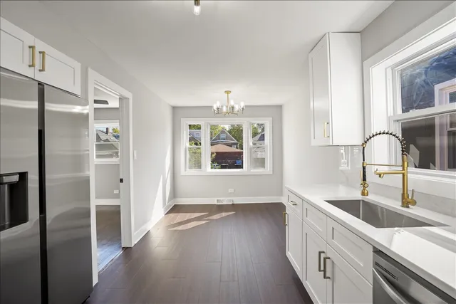 a kitchen with a refrigerator and a sink