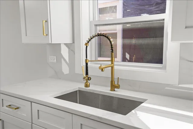 a kitchen with a sink and a window