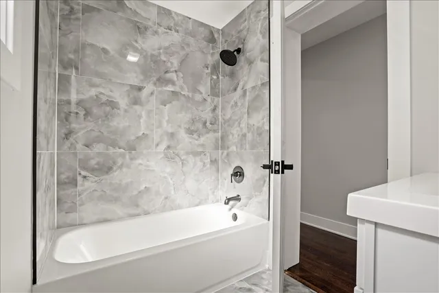 a bathroom with a bathtub and a shower