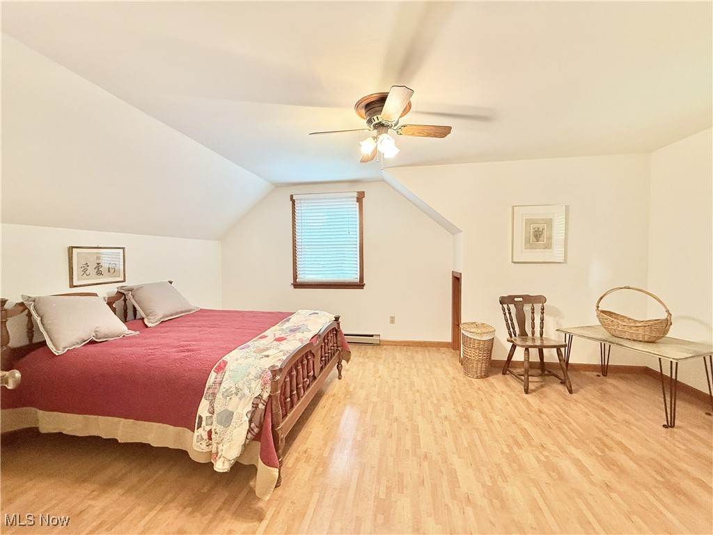 4901 Kings Creek Road Weirton, WV 26062 - Photo 18 of 28 Bedroom featuring light wood-style flooring, a baseboard radiator, lofted ceiling, and a ceiling fan