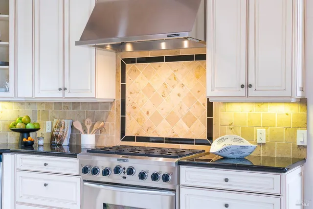 a kitchen with a stove and cabinets
