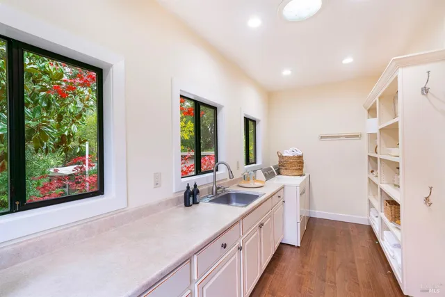 a spacious bathroom with double vanity a mirror and a shower