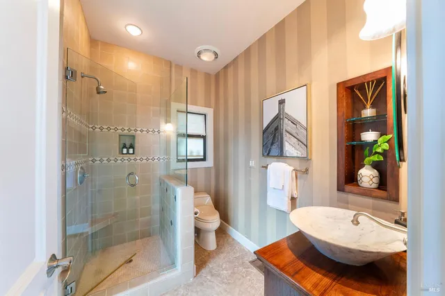 a bathroom with a sink toilet and shower