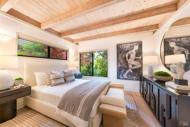 a bedroom with a large bed and a window