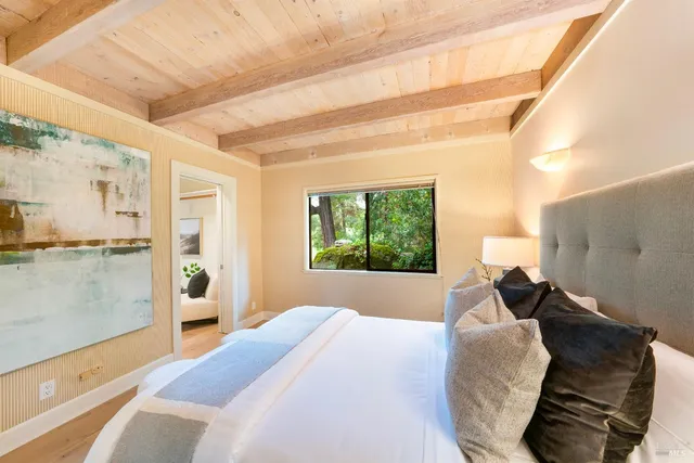 a bedroom with a bed and a window with balcony view