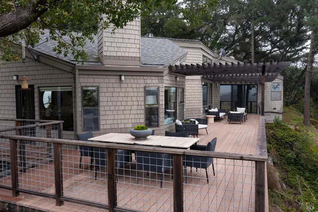 a view of a patio with table and chairs and potted plants