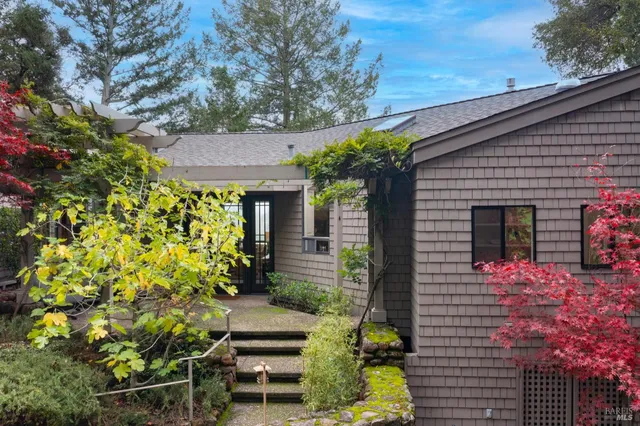 front view of a house with a tree