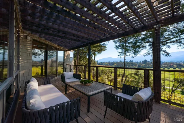 a balcony with furniture and wooden floor