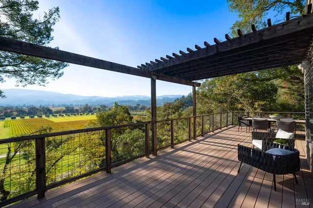 a view of balcony with chairs and wooden floor