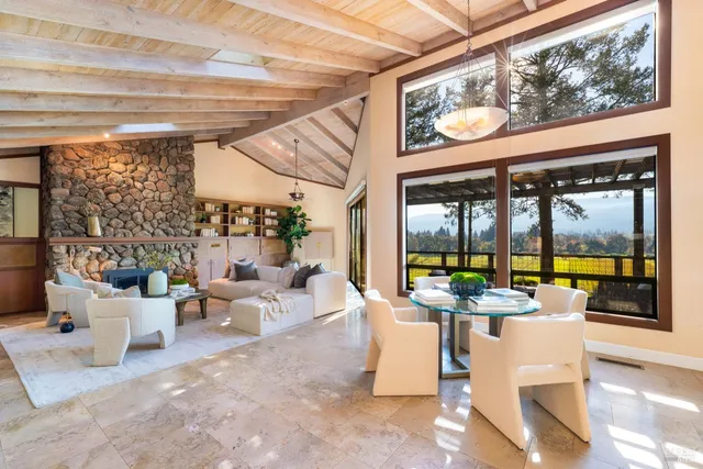 a living room with patio furniture and a floor to ceiling window