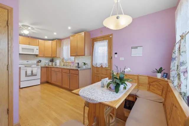 a kitchen with a table chairs sink and cabinets