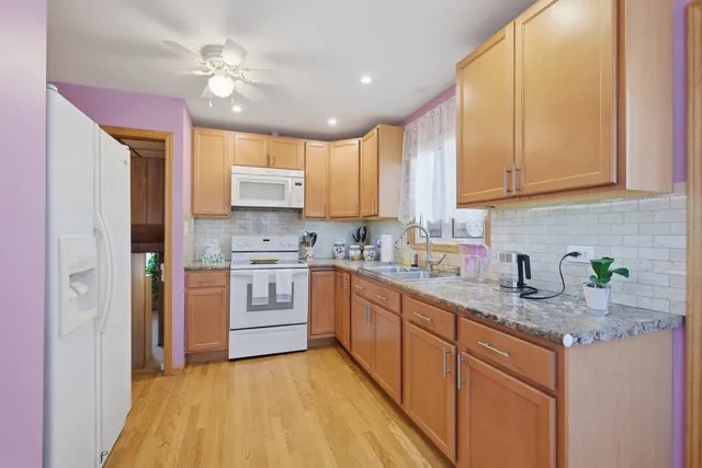 a kitchen with stainless steel appliances granite countertop a stove a sink dishwasher and a refrigerator