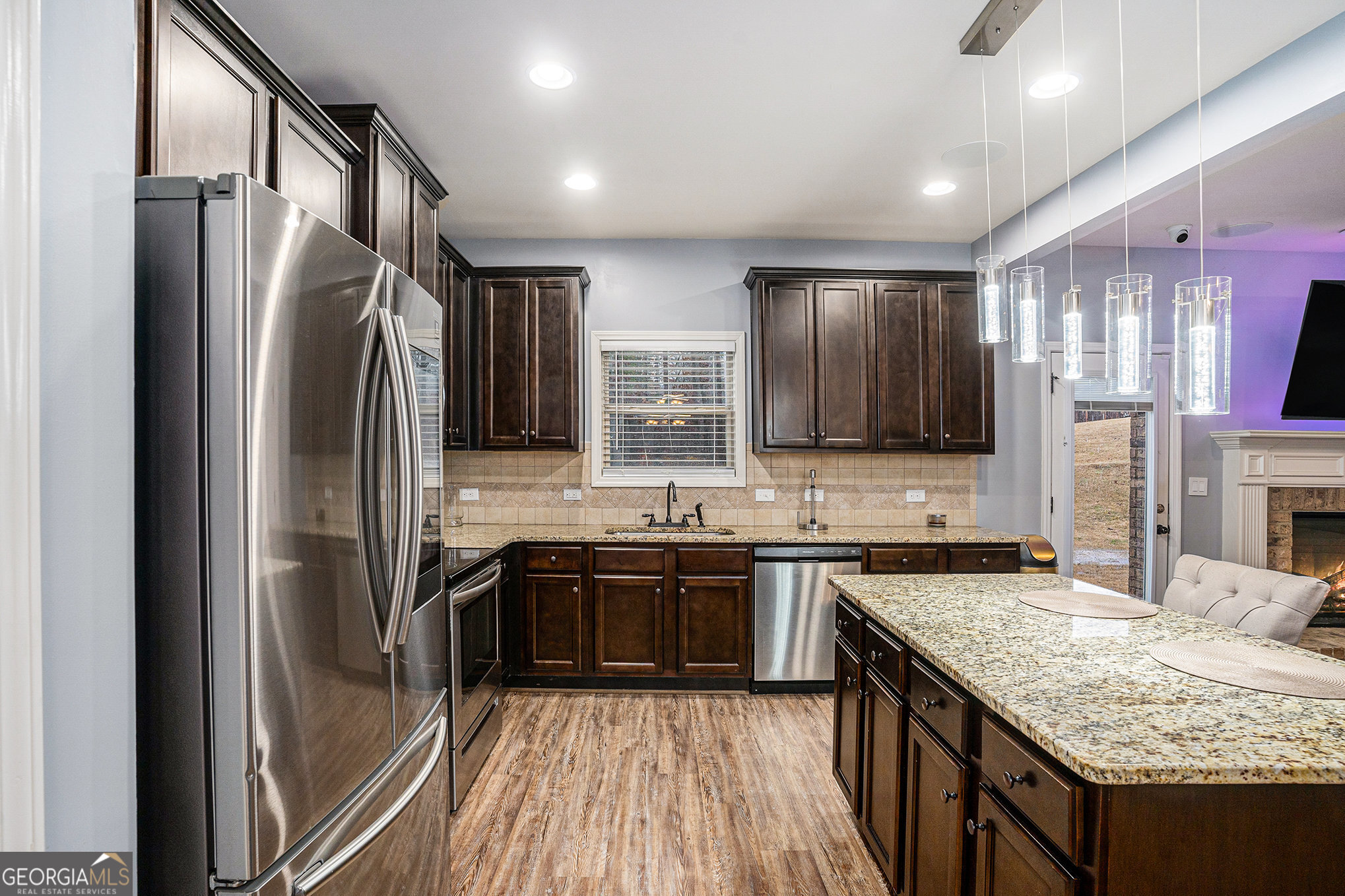 121 Amelia Way Ellenwood, GA 30294 - Photo 13 of 31 a kitchen with stainless steel appliances granite countertop a sink stove and refrigerator