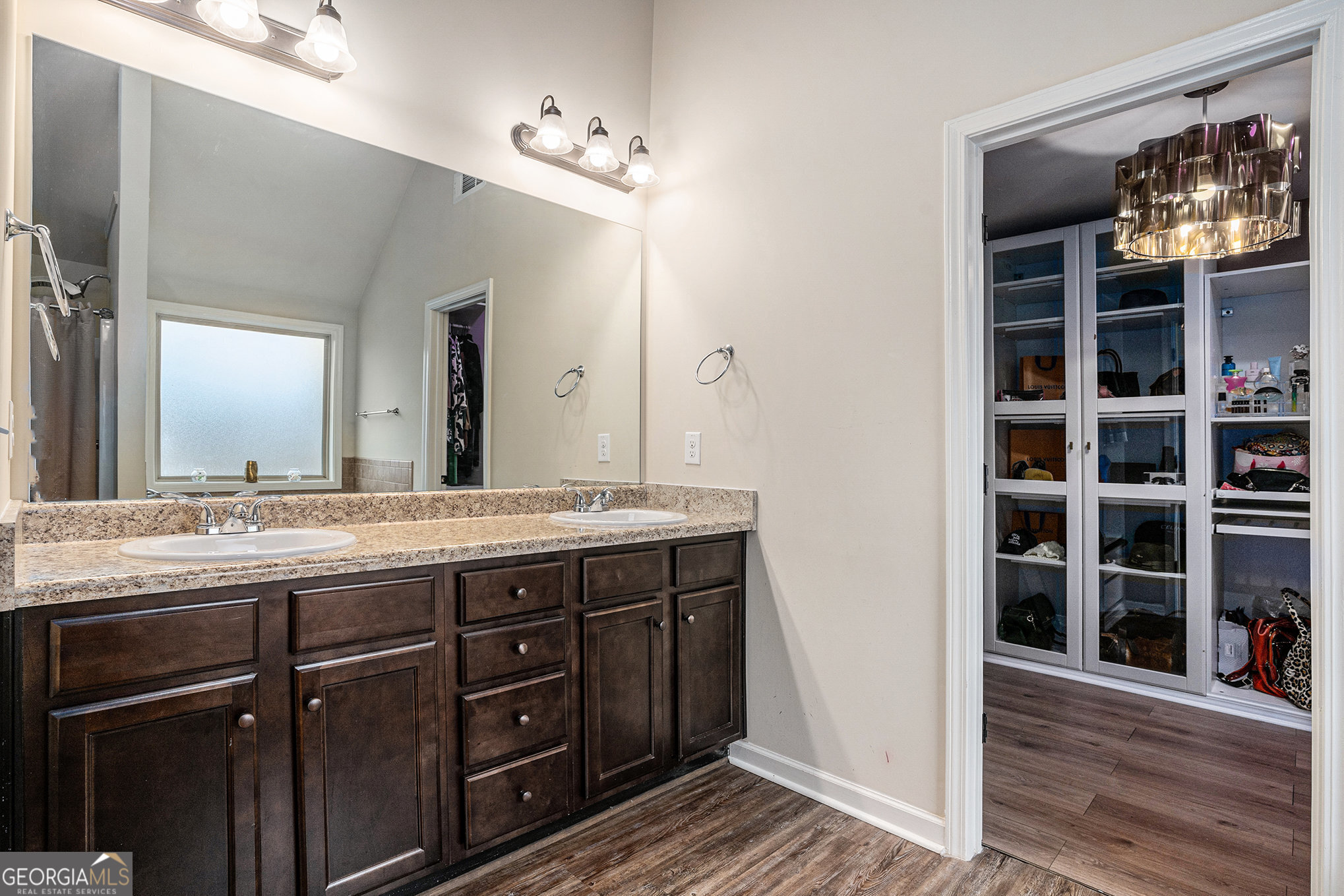 121 Amelia Way Ellenwood, GA 30294 - Photo 21 of 31 a bathroom with a granite countertop sink a mirror and a shower