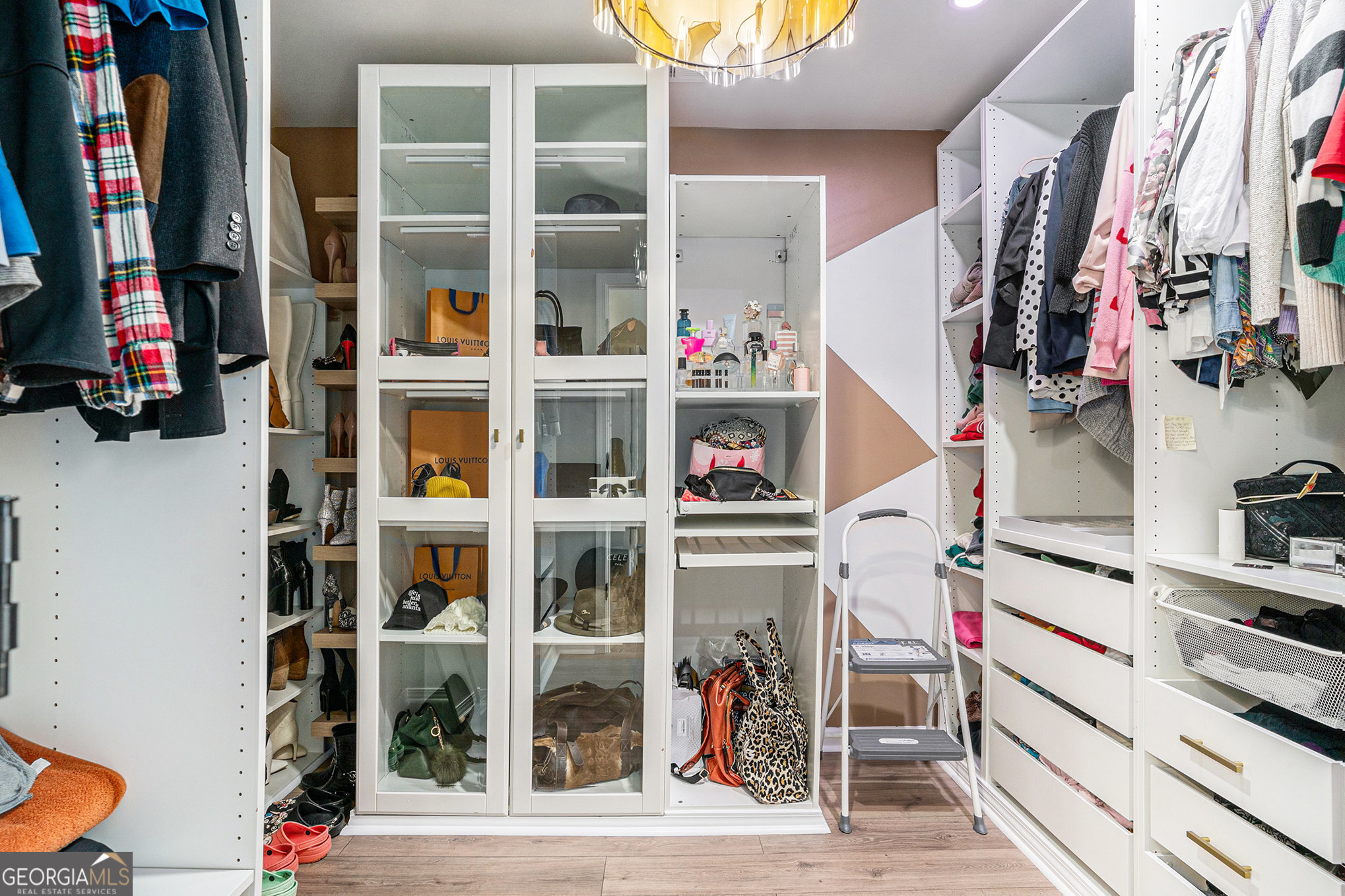 121 Amelia Way Ellenwood, GA 30294 - Photo 23 of 31 a view of walk in closet with clothes and shoes