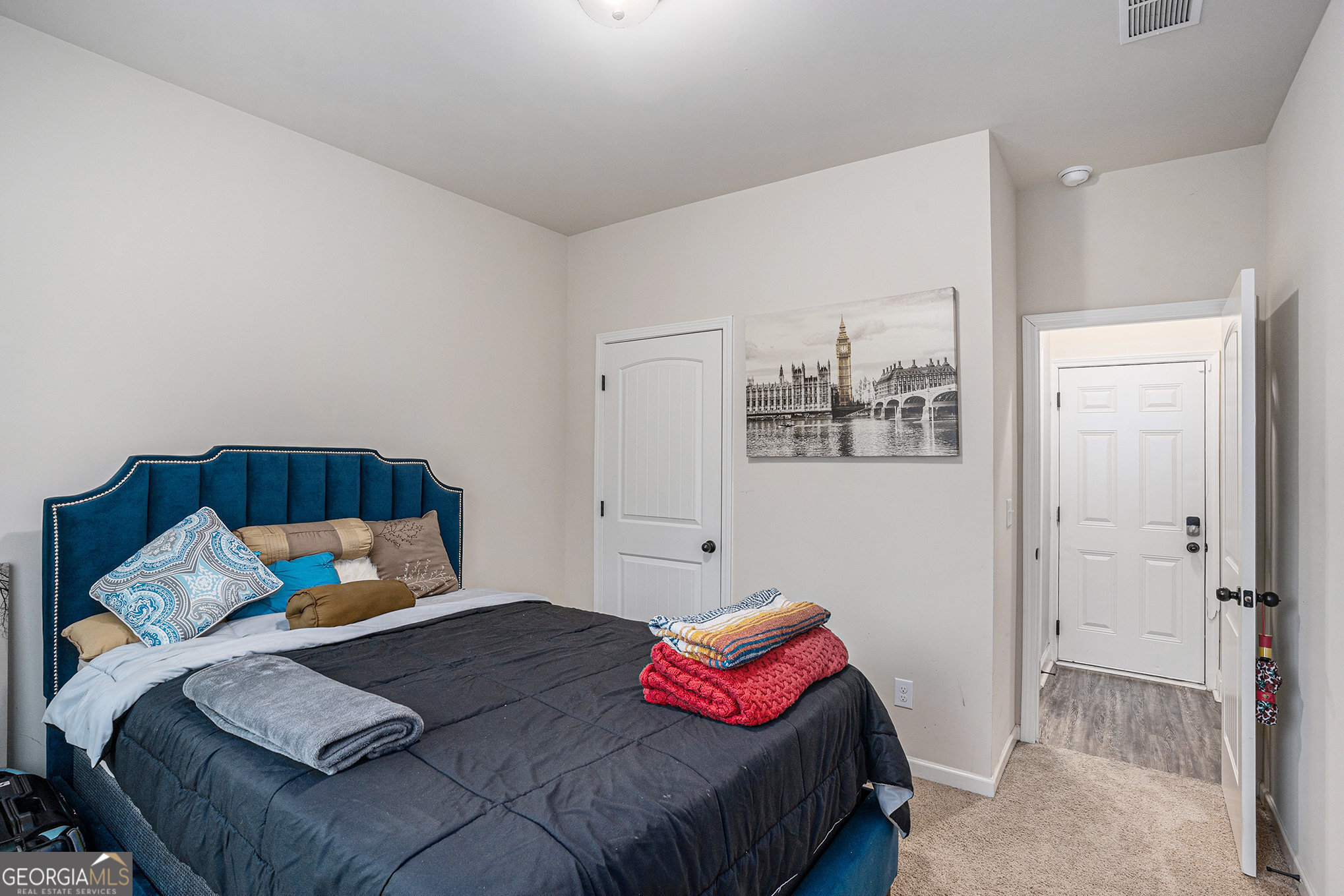 121 Amelia Way Ellenwood, GA 30294 - Photo 27 of 31 a bedroom with a bed and a couch