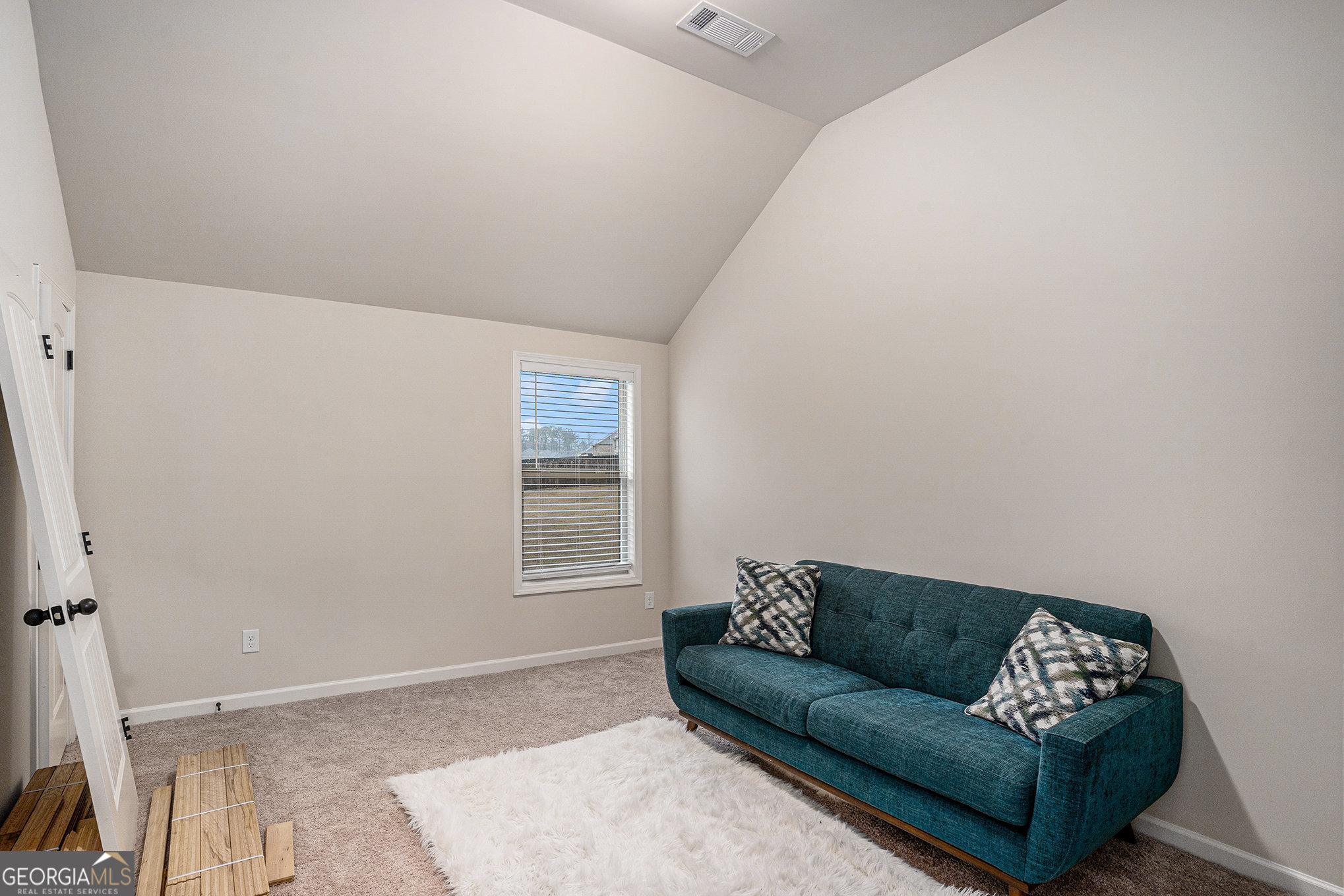 121 Amelia Way Ellenwood, GA 30294 - Photo 28 of 31 a living room with furniture and a window