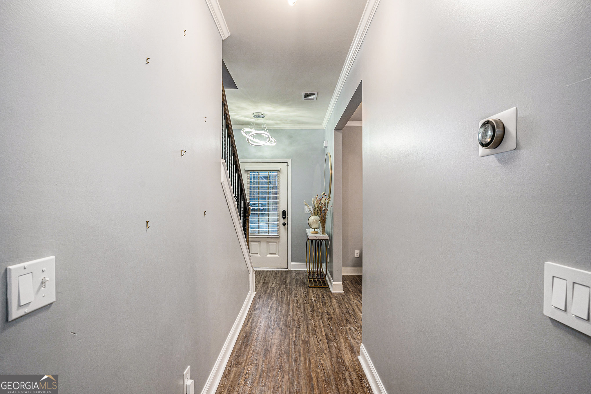 121 Amelia Way Ellenwood, GA 30294 - Photo 4 of 31 a view of a hallway with wooden floor and a bathroom