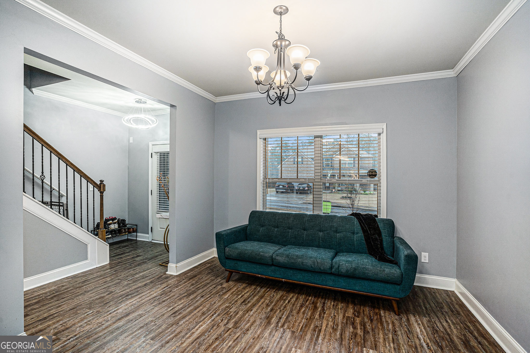 121 Amelia Way Ellenwood, GA 30294 - Photo 5 of 31 a living room with furniture and a chandelier