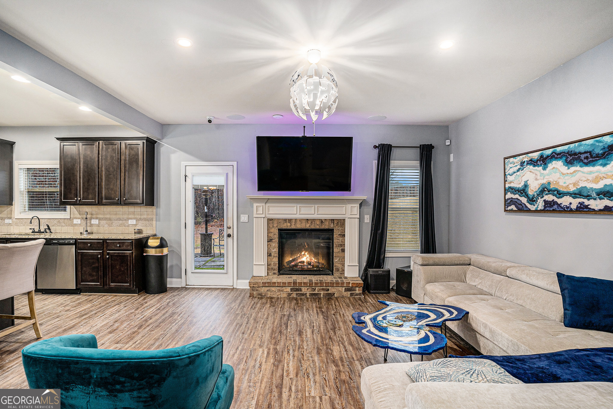 121 Amelia Way Ellenwood, GA 30294 - Photo 7 of 31 a living room with furniture fireplace a flat screen tv and kitchen view