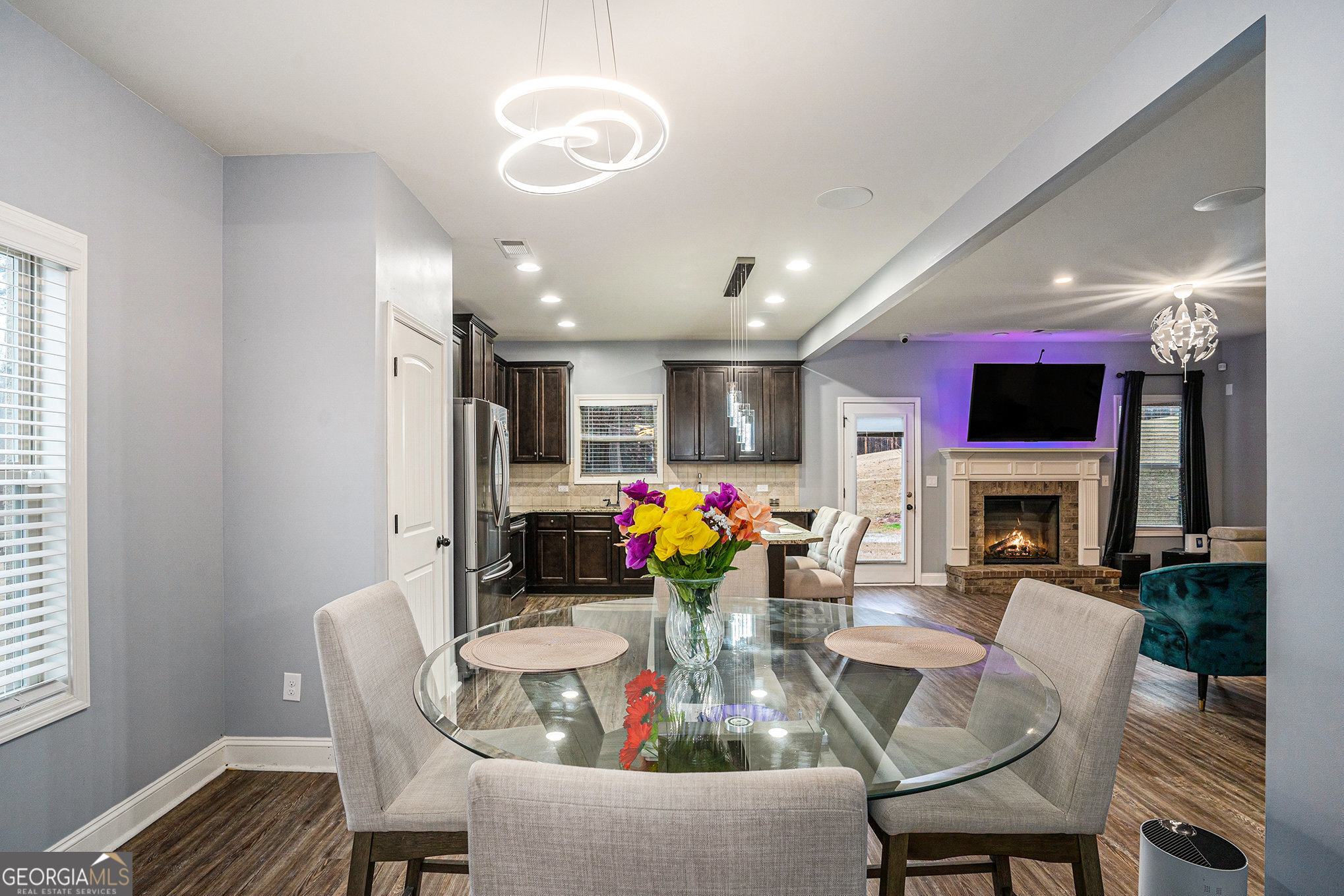 121 Amelia Way Ellenwood, GA 30294 - Photo 10 of 31 a view of a dining room with furniture a fireplace and wooden floor