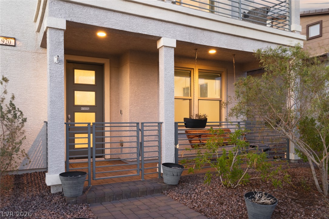 920 East Sunset Road Henderson, NV 89011 - Photo 3 of 33 A welcoming front entrance showcases modern design with a unique entry door and well-lit porch.