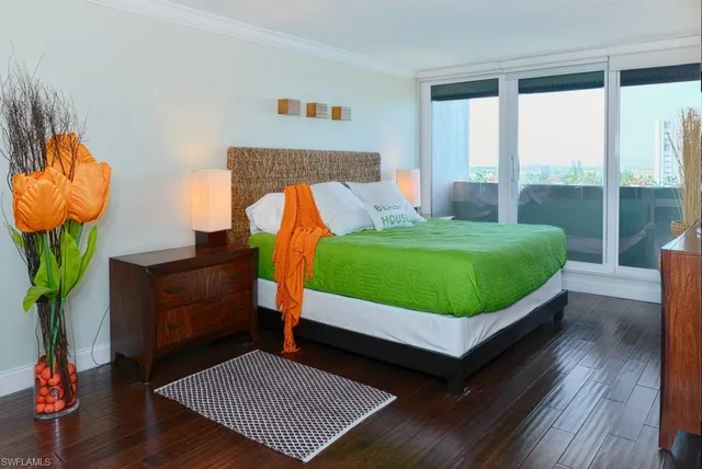 a room with a bed and a wooden floor