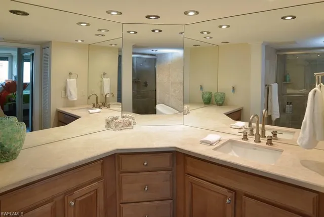 a bathroom with a sink double vanity and shower