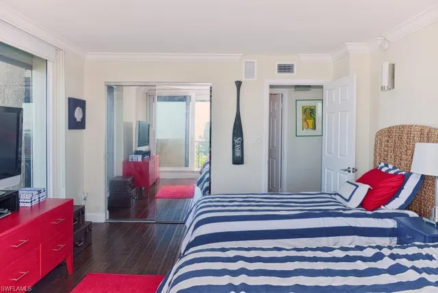 a bedroom with a bed and flat screen tv