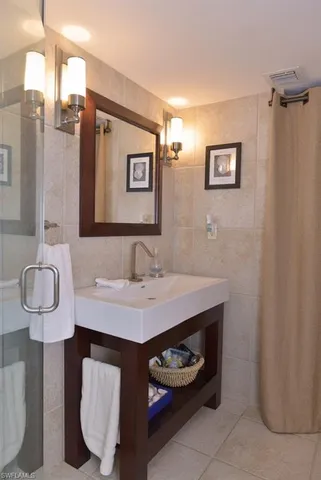 a bathroom with a sink a light fixture and a toilet