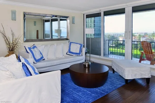 a living room with a table and a potted plant