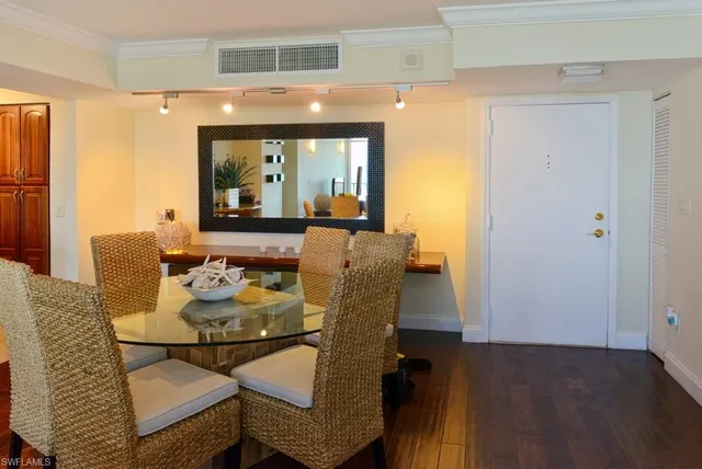 a dining room with furniture and wooden floor
