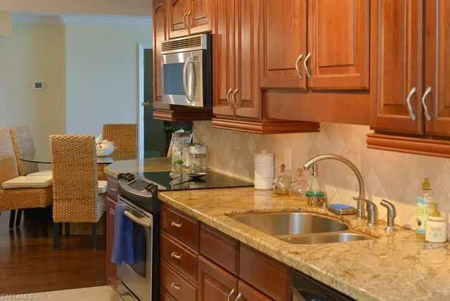a kitchen with a sink and a stove