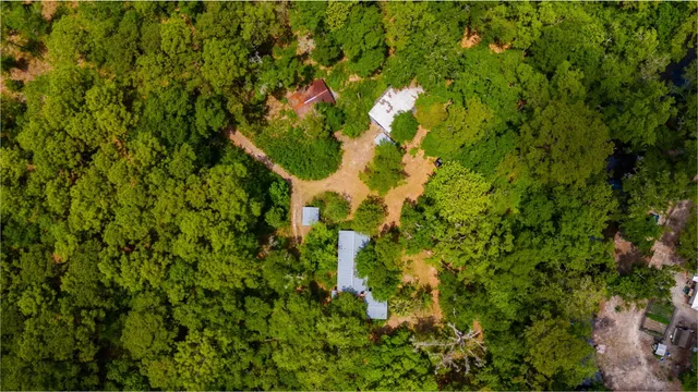 an aerial view of a house with a yard