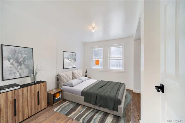 a bedroom with a bed and a painting on the wall