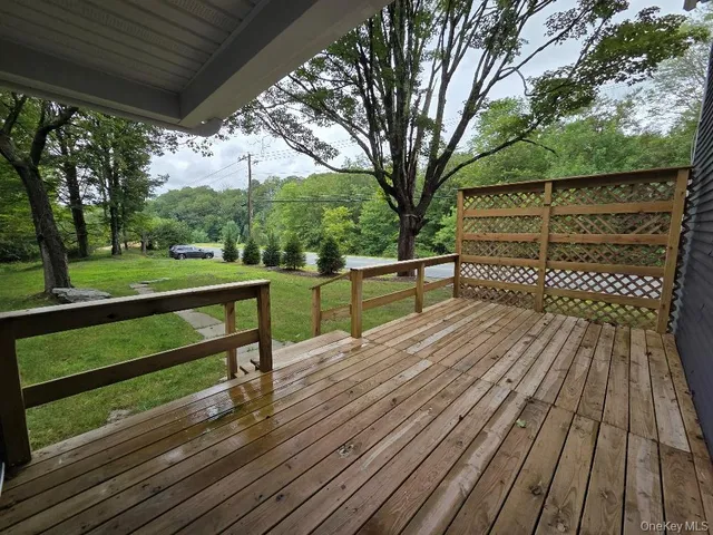 a view of a wooden deck with a yard